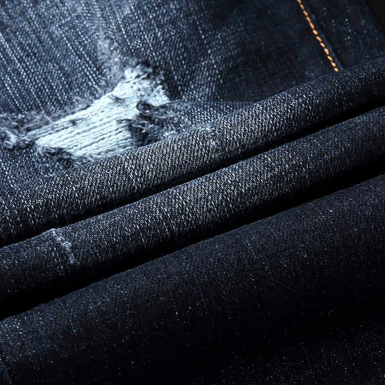 Fashionable men's worn tattered new jeans